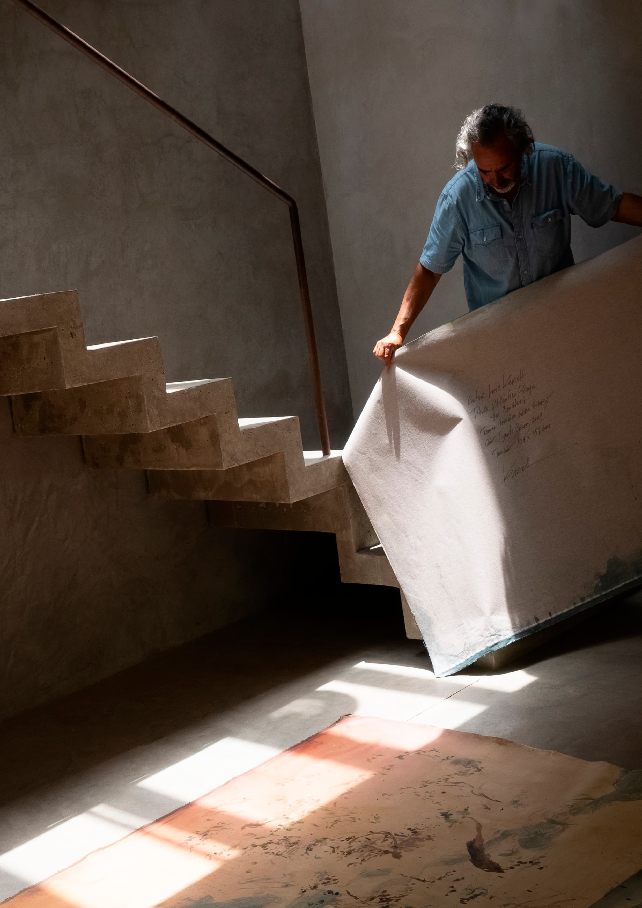 Luis Kerch displaying his paintings